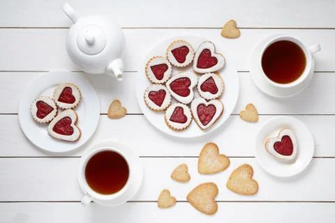 Sweet heart cookies for Valentines day with teapot and two cups of tea Stock Photos