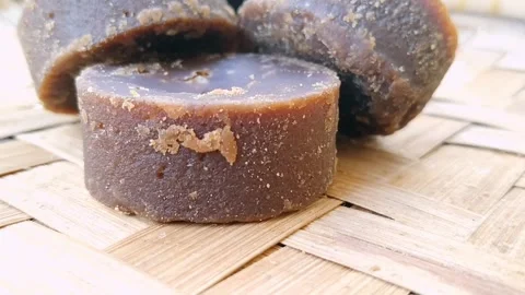 Sweet Jaggery Chunks and Dust on Woven Bamboo Mat Floor Video stock 341456205