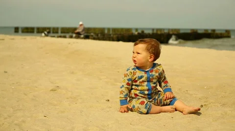 Sweet kid sitting at the beach Stock Footage 63379503