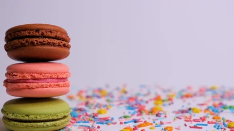 Sweet macaroons with multi colored confectionery dressing. Macro close up. Stock Footage 107186908