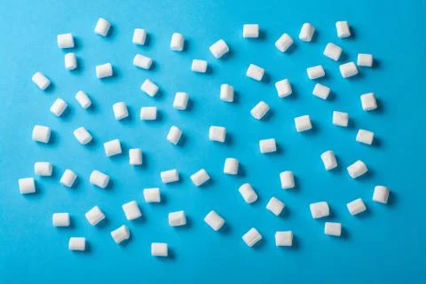 Sweet Marshmallows on blue background with a shadow. Flat lay top view Stock Photos