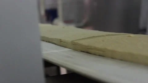 The sweet mix for making sweet bars moves on a conveyor belt. Stock Footage 128642959