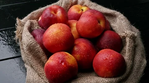 Sweet nectarines on the table with burlap cloth. organic fruit Stock Footage 157684590