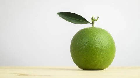 Sweet orange fruit with a single leaf isolated against a white background, Ra Stock Photos