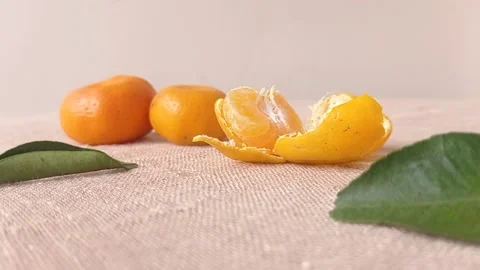 Sweet oranges and its leaf on a brown table Stock Footage 149709198