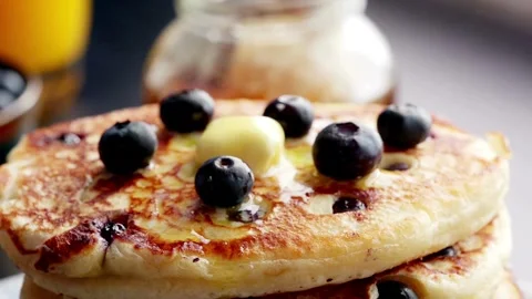 Sweet pancakes topped with maple syrup and blueberries. Tasty breakfast concept Stock-Footage 336589255