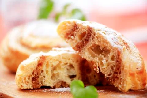 Sweet pastry rolls with nut filling dusted with icing sugar Stock Photos