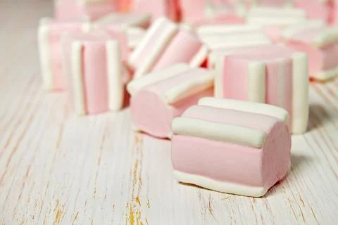 Sweet pink marshmallows on white table Stock Photos