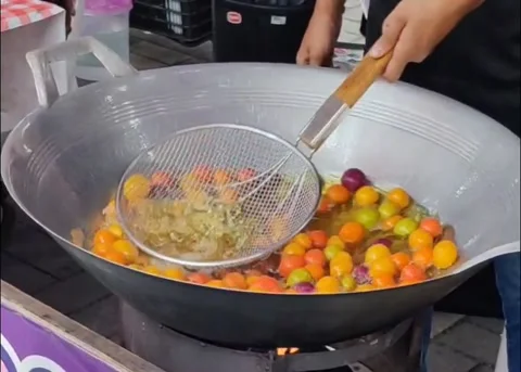 Sweet potato balls being deep fried in a large wok Stock Footage 323651577