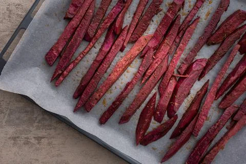 Sweet potato wedges on a baking sheet Stock Photos