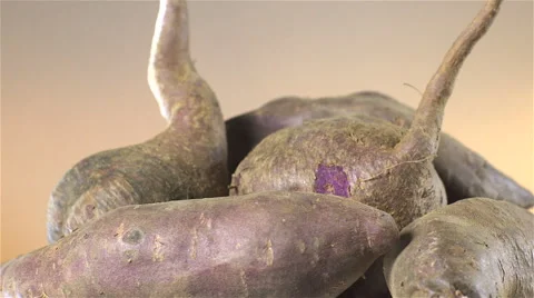 Sweet Potatoes isolated rotating on brown background Stock Footage 62187955
