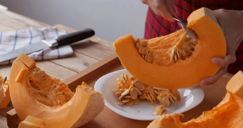 Sweet pumpkin preparing, removing seeds, close-up Stock Footage 146140780