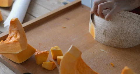 Sweet pumpkin skin peeling using sharp knife Stock Footage 147513671