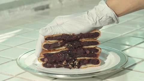 Sweet Red Bean Paste Oozing from Soft Bread When Pressed by Hand Stock Footage 335613919
