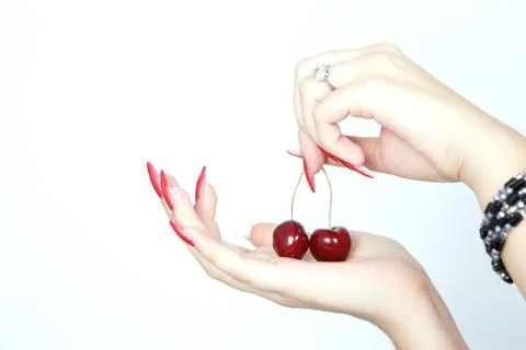 Sweet red cherries on woman's hand Stock Photos