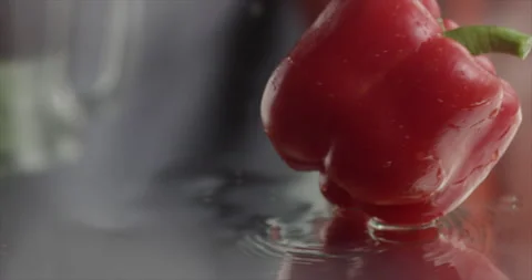 Sweet red pepper fall on a mirror surface Stock Footage 198147737