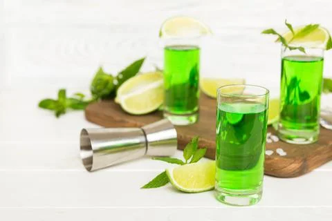Sweet refreshing mint liqueur, with ice and mint leaves on table background,  Stock Photos