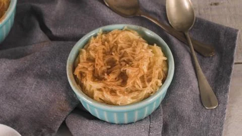 Sweet rice pudding dusted with cinnamon in small turquoise bowl Stock Photos