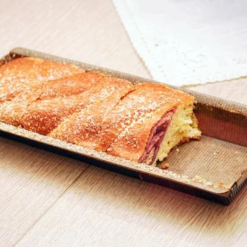 Sweet roulade from the store on the table Stock-Fotos