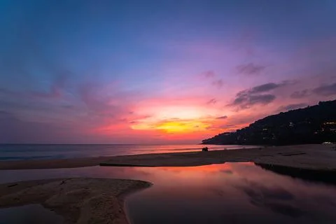 Sweet sky at sunset reflection in the beach puddle. Stock Photos
