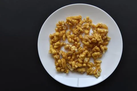Sweet snack chuck-chuck in a package on a white plate. Honey snack made of do Stock Photos