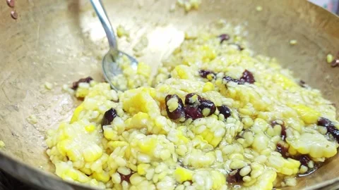 Sweet sticky rice with corn and beans in a brass wok. Stock Footage 343093032