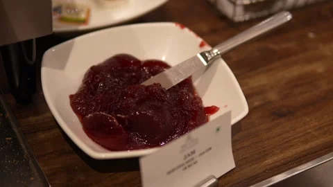 Sweet Strawberry Jam Served in White Bowl with Spoon at Breakfast Buffet Vídeo Stock 341655209