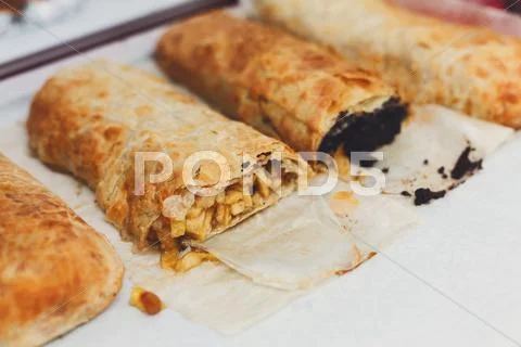 Sweet strudel with poppy and apples choice on trays Stock Photos