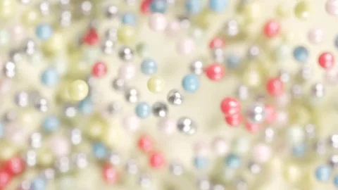 Sweet sugar sprinkles explosion, multicolor balls on yellow background. Stock Footage 309098035