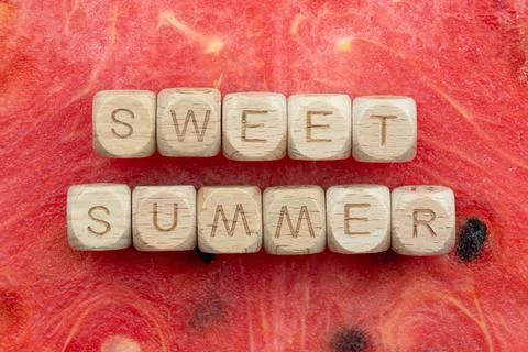 Sweet summer message on watermelon background with wooden alphabet blocks Stock Photos