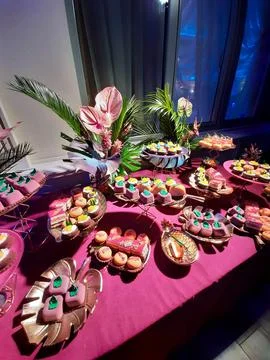 Sweet table with cakes of different shapes round square pyramidal. Table in.. Stock Photos