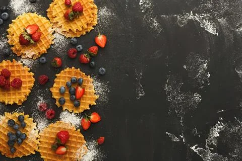 Sweet tart shells with mixed berries on dark surface Stock Photos