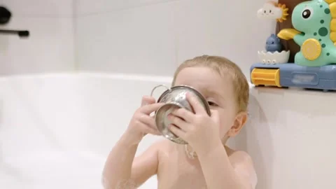 A sweet toddler plays during a bath time Stock Footage 329588435