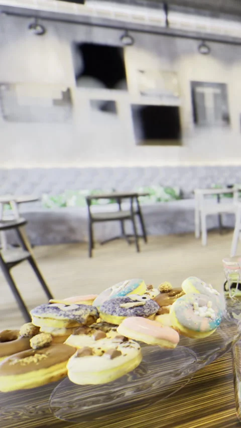 Sweet treats served on a table inside a modern cafe with empty chairs 스톡 동영상 333564667