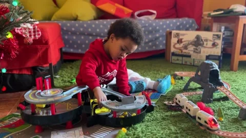 Sweet two-year-old black baby playing at home with his new Christmas Stock Footage 228942985