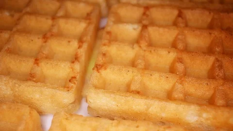 Sweet waffles closeup texture video on rolling rotating looping plate Stock Footage 104325080