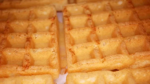 Sweet waffles closeup texture video on rolling rotating looping plate Stock Footage 104330107