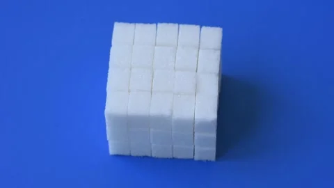 Sweet white sugar cubes as a source of glucose. White sugar cubes as a food back Stock Footage 323871618