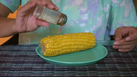 Sweet Yellow Corn Fresh Boiled and Hot on a Plate on Lunch. Girl hands Stock Footage 170167045