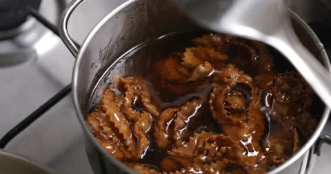 Sweetening up chebakia: the syrup bath Stock Footage 236544335