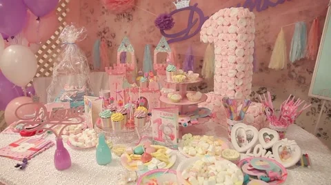 Sweets and decorations on the table to celebrate 1 year baby Stock Footage 63783321