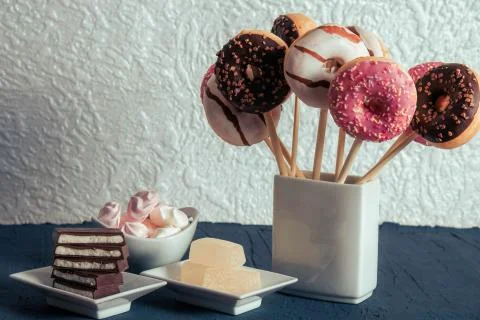 Sweets are on the table, next to donuts in a vase Stock Photos
