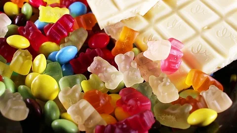 Sweets. Chocolate candies candy texture gum gummy bears bear and bonbons Stock Footage 98790356