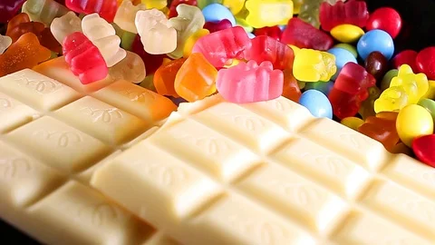 Sweets, chocolates, white chocolate bar gummy bears Stock Footage 110610016