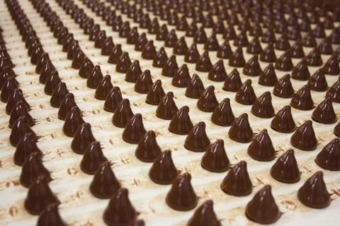 Sweets on a conveyor Stock Photos