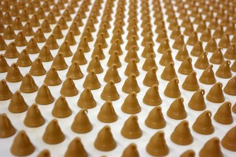 Sweets on conveyor Stock Photos