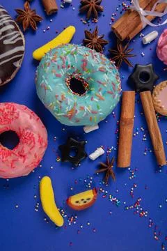 Sweets donuts and candy vanilla pods on a blue background. Stock Photos