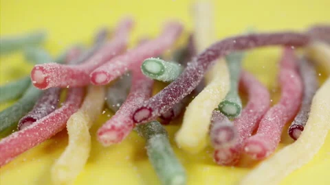 Sweets falling on a pastel background . Super slow motion 1000 fps Stock Footage 281562557