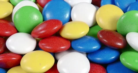 Sweets in the form of multi-colored pebbles, poured with colored glaze. Stock Footage 167582358