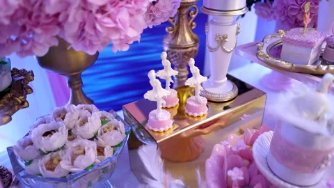 Sweets table with pink swan and decorative ballerina at birthday party Stock Footage 266073040